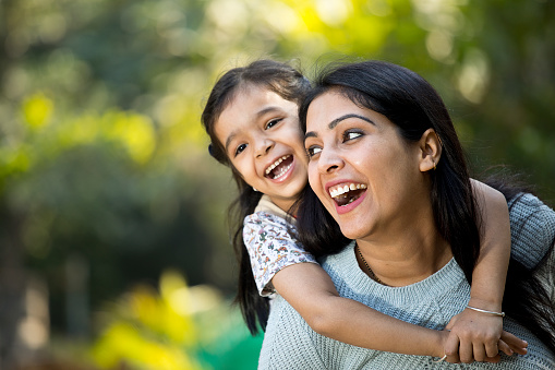 Loving mother and daughter spending leisure time at park